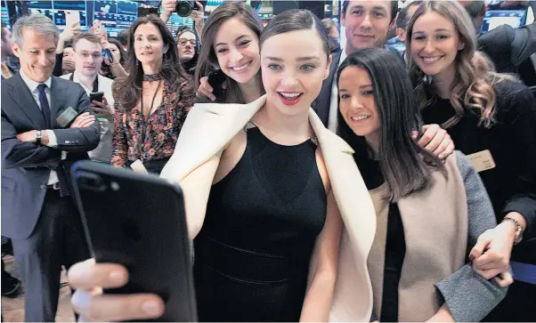  ??  ?? Australian model Miranda Kerr takes a selfie at the opening bell, as Snap lists on the New York Stock Exchange. Kerr is engaged to Evan Spiegel, co- founder of Snap Inc.