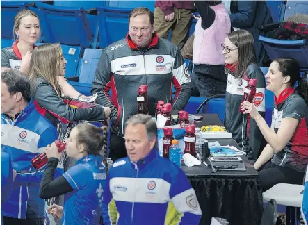  ?? ANDREW VAUGHAN / THE CANADIAN PRESS ?? Ontario coach Marcel Rocque, centre, talks with the members of Rachel Homan’s rink during the fifth-end break at the Scotties Tournament of Hearts at Centre 200 in Sydney, N.S., on Monday.