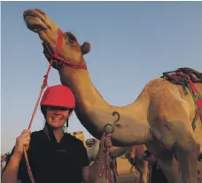  ?? EPA ?? Sarah Collins from New Zealand celebrates after winning the first Female Camel Racing in Dubai in October race