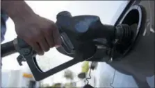  ?? AP PHOTO/RICH PEDRONCELL­I, FILE ?? A motorist puts gas in his car at a Shell station in Sacramento, Calif. Escalating tensions in the Middle East and elsewhere could threaten oil supply, which could push the price of oil and gasoline higher.