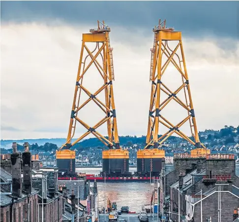  ?? ?? HUGE VISITORS: The foundation­s for the offshore wind farm sail past Broughty Ferry. Picture by Adam le Grice.