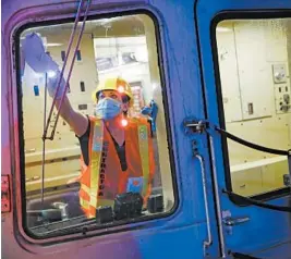  ?? JOHN MINCHILLO/AP ?? A contractor cleans a subway car to control the spread of COVID-19 on July 2 at the 96th Street station in New York City.