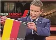  ?? FOTO: DPA ?? Björn Höcke hängt in der ARD-Talkshow „Günther Jauch“eine Deutschlan­dfahne über seinen Sessel.