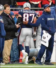  ?? ADAM GLANZMAN / GETTY IMAGES ?? Patriots tight end Rob Gronkowski gets helped off the field after being shaken up on a helmet-to-helmet hit during the victory over the Jaguars in the AFC Championsh­ip game Sunday.