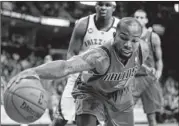  ??  ?? Dallas’ Dominique Jones chases down a loose ball during the Mavericks’ 92-82 loss to Memphis. O.J. Mayo, Dallas’ leading scorer, was held to 10 points on 3-of-11 shooting.