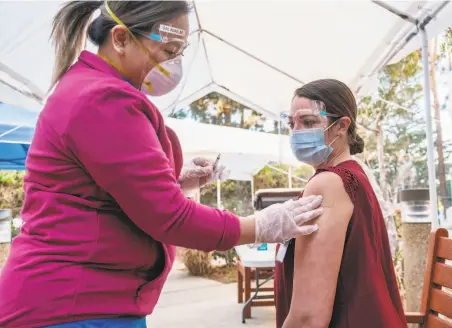  ?? Nick Otto / Special to The Chronicle ?? Nurse Teri Grados gets a COVID19 inoculatio­n as part of the state’s Phase 1a vaccinatio­ns. Older people could be in Phase 1b.