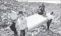  ?? ?? MYSTERY IN THE AIR: Flight MH370 lost all radar contact while flying over the South China Sea toward Vietnam. This piece of debris was found washed up on a beach on Réunion island off the coast of Africa in 2015.