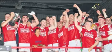  ?? (Pic: George Hatchell) ?? Ben Cunningham, man of the match and captain Michael Mullins lift the trophy as Cork celebrate victory over Clare in the O’Neills.com Munster U20 Hurling final at Limerick’s Gaelic Grounds.