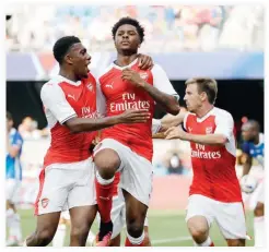  ??  ?? WINNER: Arsenal forward Chuba Akpom, center, celebrates his goal with teammate Alex Iwobi, left, during the second half of the MLS All-Star soccer game against the MLS All-Stars in San Jose, California, Thursday. (AP)