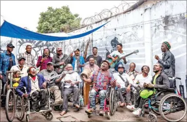  ?? AFP ?? The members of Staff Benda Bilili pose for a group photo during a rehearsal in the popular district of N’djili, Kinshasa.