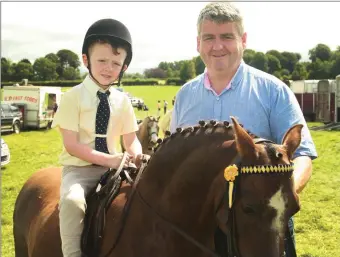  ??  ?? Oliver Walsh with his son Ollie in the lead rein class.