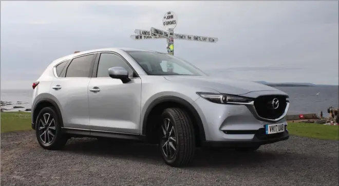  ??  ?? The Mazda CX-5 cuts a fine figure at John o’ Groats as it explores the top of Scotland, uncovering vistas such as the A832 over Loch Maree.