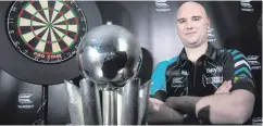  ??  ?? Life-changing: Rob Cross with his World Championsh­ip trophy