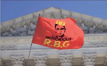  ?? Alex Wong / Getty Images ?? An RBG flag is flown in front of the U.S. Supreme Court for the late Justice Ruth Bader Ginsburg Monday in Washington, D.C. Ginsburg died Friday from complicati­ons of pancreatic cancer at 87.