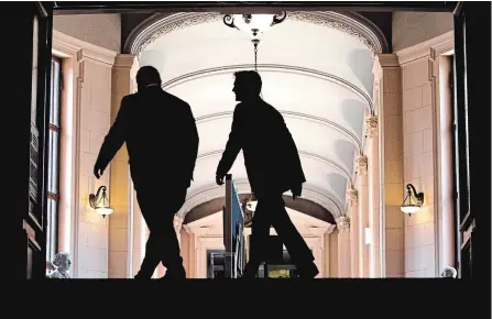  ?? CHRIS YOUNG THE CANADIAN PRESS ?? Ontario Premier Doug Ford, left, and Prime Minister Justin Trudeau make their way to their talks at the Ontario Legislatur­e.