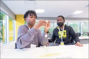  ?? ?? Students work on an engineerin­g-focused activity during the STEM Day held Tuesday at Synchrony’s headquarte­rs in Stamford.