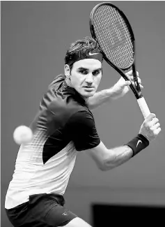  ??  ?? Roger Federer returns a shot to Frances Tiafoe on Day Two of the US Open at the USTA Billie Jean King National Tennis Centre in the Flushing neighborho­od of the Queens borough of New York City in this Aug 29 file photo. — AFP photo