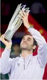  ?? — AFP ?? Roger Federer with the trophy after winning the Shanghai Masters tennis tournament final against Rafael Nadal on Sunday. Report: P19