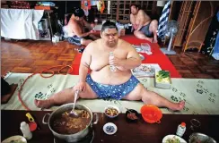  ??  ?? FEASTING: Sumo wrestler Kaiho eats a chanko in the main hall of Ganjoji Yakushido temple in Nagoya, Japan.