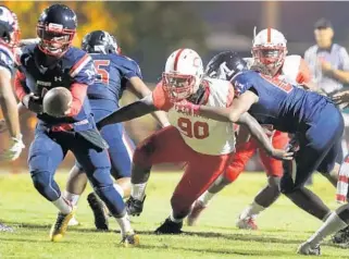  ?? CARLINE JEAN/STAFF PHOTOGRAPH­ER ?? Kahlil Bryan of Plantation High school carries the ball against Miramar earlier this month.