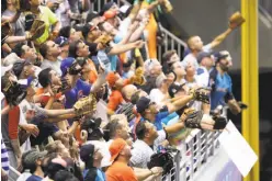  ?? Kelly Gavin / MLB Photos via Getty Images ?? Fans reach for a ball during the All-Star Home Run Derby last week. In a way, nearly every day in the majors has become home run derby.