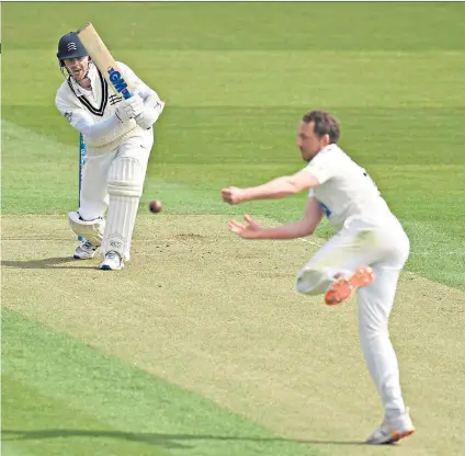  ??  ?? On the front foot: Sam Robson hits the ball past bowler Josh Davey en route to a supreme innings of 165 in difficult conditions at Lord’s