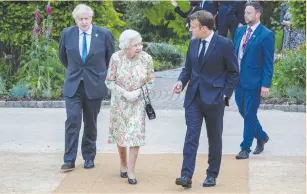  ?? (Jack Hill/Pool via Reuters) ?? BRITAIN’S QUEEN ELIZABETH, Prime Minister Boris Johnson and France’s President Emmanuel Macron attend a drinks reception on the sidelines of the G7 summit, at the Eden Project in Cornwall, England, on Friday.