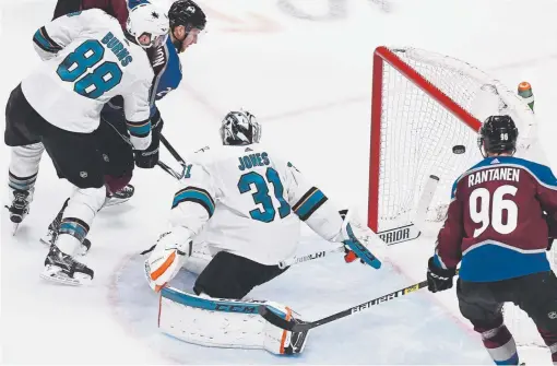  ?? Andy Cross, The Denver Post ?? Avalanche center Nathan MacKinnon scores a goal against San Jose Sharks goaltender Martin Jones during the second period Thursday night at the Pepsi Center in Game 4 of the second-round playoff series.