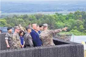  ?? SUSAN WALSH/ASSOCIATED PRESS ?? President Donald Trump views North Korea from the Korean Demilitari­zed Zone from Observatio­n Post Ouellette at Camp Bonifas in South Korea this morning.