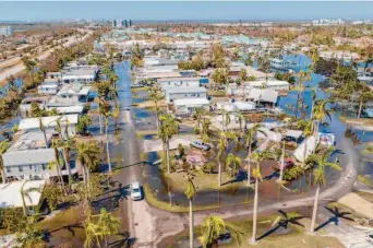  ?? Steve Helber/Associated Press ?? Floodwater fills a trailer park in Fort Myers, Fla., on Oct. 1 after Hurricane Ian churned across the region. The Category 4 storm was the third deadliest to hit the U.S. mainland this century.