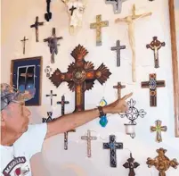  ?? JOHN LARSON/EL DEFENSOR CHIEFTAIN ?? Exhibit organizer Matt Middleton points out a handmade cross from southern Mexico. All crosses are for sale and the show continues every weekend through the summer months.