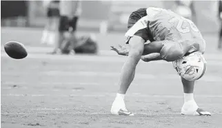  ?? LYNNE SLADKY/AP ?? Long snapper John Denney works on his craft during an earlier practice session this summer.