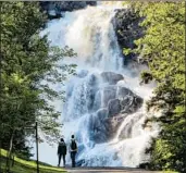  ?? R.M. GREEN/AP ?? The Ouiatchoua­n waterfall is a popular stop for cyclists on the Blueberry Trail around Quebec’s Lac-Saint-Jean.