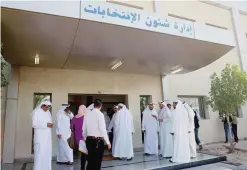  ?? —Photos by Yasser Al-Zayyat ?? KUWAIT: Kuwaitis wait in front of the election affairs department yesterday as Kuwaiti candidates arrive to register for the upcoming parliament­ary elections.