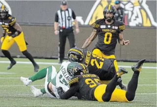  ?? PETER POWER THE CANADIAN PRESS FILE PHOTO ?? Saskatchew­an Roughrider­s quarterbac­k Zach Collar is hit late by Tiger-cats’ Simoni Lawrence after Collaros was downed by Julian Howsare in Hamilton on June 13, 2019.