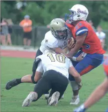  ?? TONY MALUSO / The Daily Citizen ?? Calhoun’s James Prater (10) and Collin Baggett combine to bring down Northwest Whitfield’s Dominique Sistrunk during the first half on Friday.