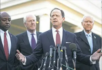  ?? Getty Images ?? Talking with reporters Monday after meeting with President Donald Trump in Washingto, D.C., are Senate Finance Committee members, from left, Tim Scott, R-S.C.; John Cornyn, R-Texas; Pat Toomey, R-Pa.; and Chairman Orrin Hatch, R-Utah. Senate...