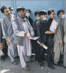  ??  ?? DESPERATE Afghans queue at the passport office in Kabul