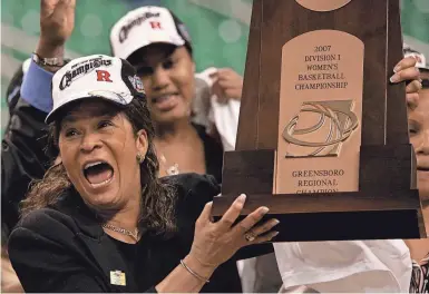  ?? ?? Rutgers coach C. Vivian Stringer, who retired last week, holds the trophy after Rutgers defeated Arizona State in the regional final of the NCAA women’s basketball tournament in Greensboro, North Carolina, in 2007. MARY ANN CHASTAIN/AP