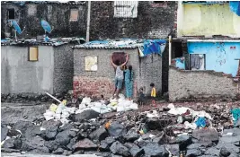  ?? RAJANISH KAKADE THE ASSOCIATED PRESS ?? A fisherman’s family seals up their window before cyclone Nisarga makes landfall in Mumbai, India, on Wednesday.