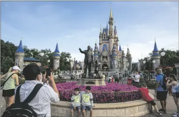  ?? AP PHOTO/TED SHAFFREY ?? People visit the Magic Kingdom Park at Walt Disney World Resort in Lake Buena Vista, Florida, on April 18, 2022.