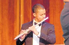  ?? MICHAEL RECKORD ?? Brian Morris playing his flute at the Philharmon­ic Orchestra of Jamaica concert in The University Chapel.