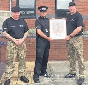  ??  ?? Royal Signals soldiers present a picture to the police in thanks for the scrambler bikes