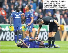  ??  ?? A day to forget... Bamba holds his leg after suffering a serious knee injury at Wolves last term