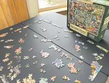  ?? Joshua Berman, Special to The Denver Post ?? The closest travel columnist Joshua Berman and his family will get to a national park in spring 2020, during the COVID-19 pandemic, is this 1,000-piece National Parks of America puzzle.