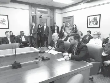  ?? Andrew DeMillo/Associated Press ?? ■ Arkansas Rep. Joe Jett, left, and Sen. Jonathan Dismang, right, speak to the House Revenue and Tax Committee on Tuesday at the state Capitol in Little Rock about a proposal to cut the state’s top income tax rate.