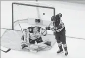  ?? Jeff Roberson Associated Press ?? ST. LOUIS’ Jake Neighbours (63) slips the puck past rookie Ducks goalie Lukas Dostal. The Blues won 4-2.