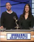  ??  ?? Matt Trebek, left, and Emily Trebek, children of the late Alex Trebek, accept the award for outstandin­g game show host for “Jeopardy!” on his behalf.