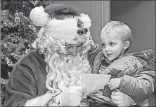  ?? [ANDY MATSKO/REPUBLICAN-HERALD] ?? Santa Claus gets a Christmas list from Owen Labie, 3, of Girardvill­e, Pa., during St. Nick’s recent visit to the Girard Hose Co. in Girardvill­e.