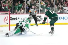  ?? (AP Photo/Abbie Parr) ?? Minnesota Wild left wing Matt Boldy (12), right, shoots and scores a goal past Dallas Stars goaltender Jake Oettinger (29) during a penalty shoot-out of an NHL hockey game Friday in St. Paul, Minn.